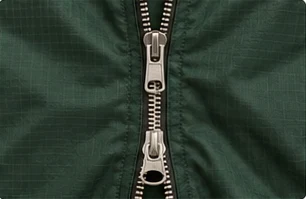 Exposed two-way metal zip on green ripstop outerwear
